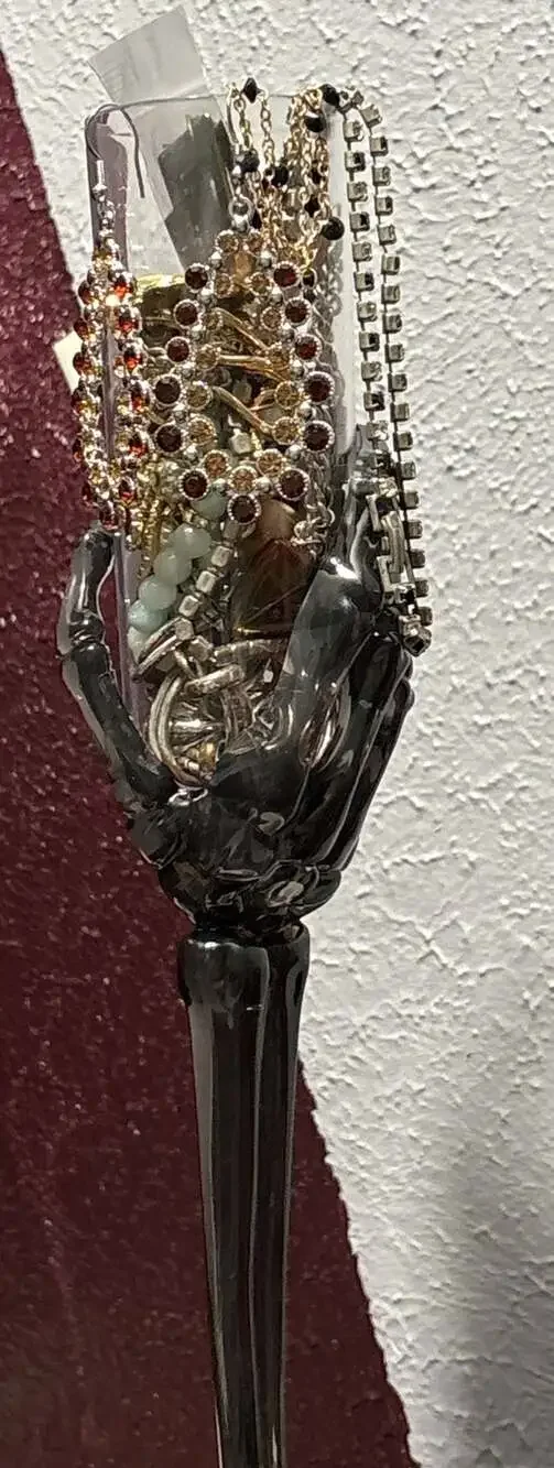 Trick or treat yourself to a skeleton hand on a flute full of jewelry